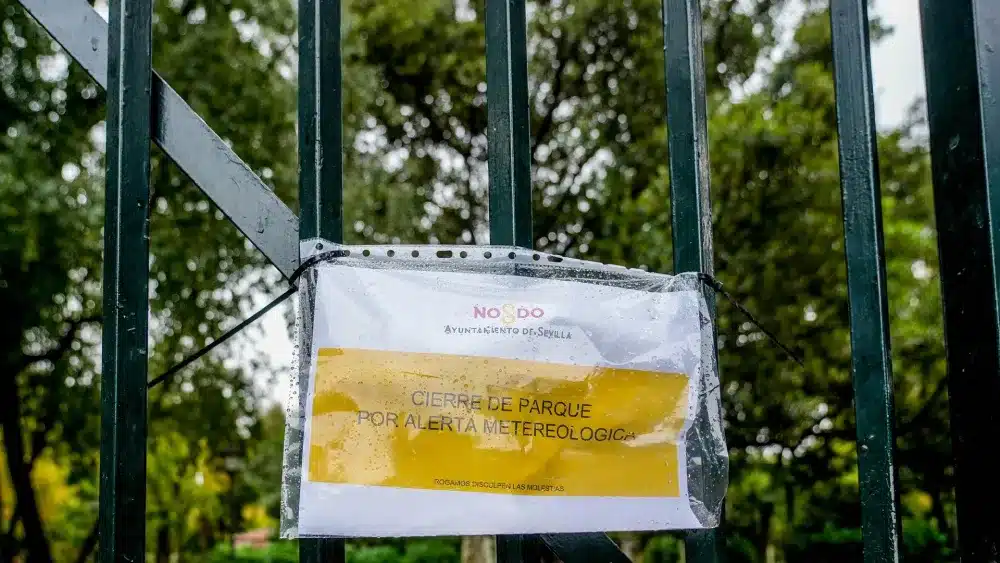 Archivo - Cartel en una reja de entrada al Parque de María Luisa que indica el cierre por alerta meteorológica. Imagen de archivo. - Eduardo Briones - Europa Press - Archivo